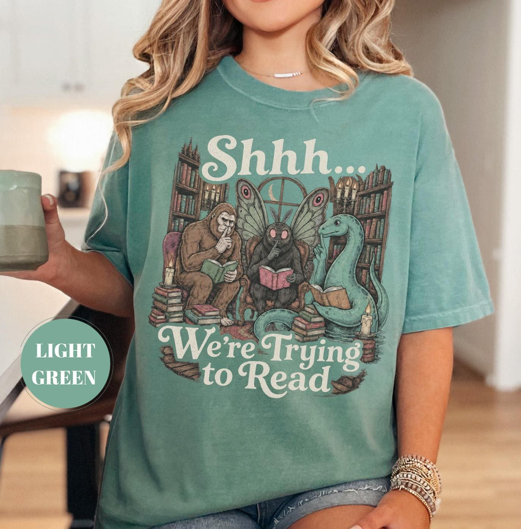 Shhh We'Re Trying Read Cryptid Bigfoot Mothman Nessie Bookish Tee Book Lover Dark Academia Reading Librarian