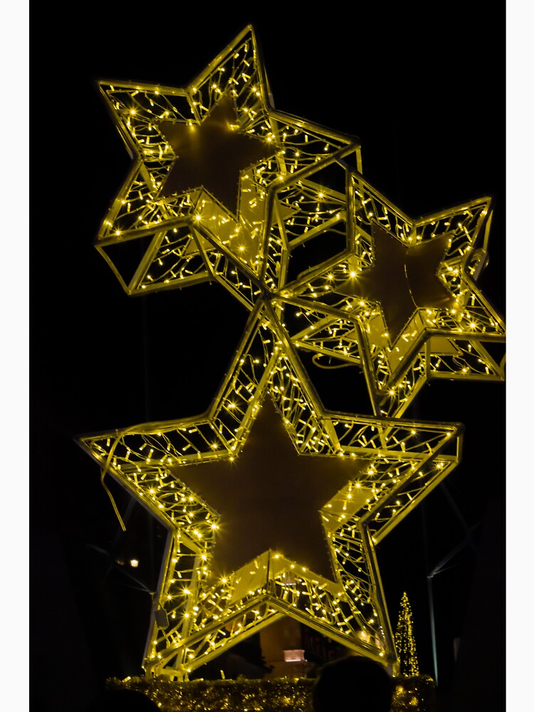 Golden Illuminated Star Christmas Lights Decoration At Night For Holiday Festive Display by Nmallia